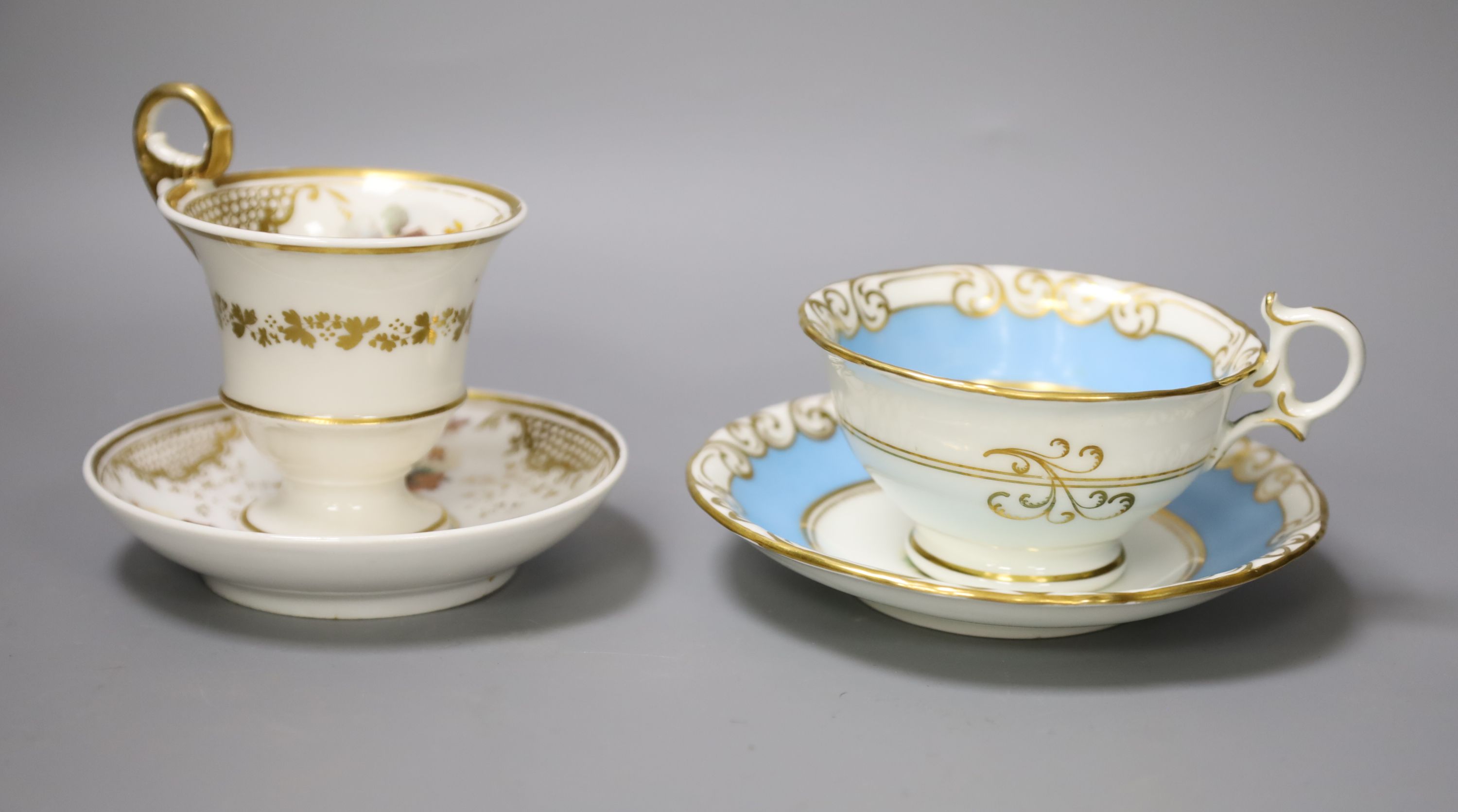 A Graingers Worcester turquoise ground teacup and saucer painted with landscapes, Royal Warrant mark and a high pedestal coffee cup